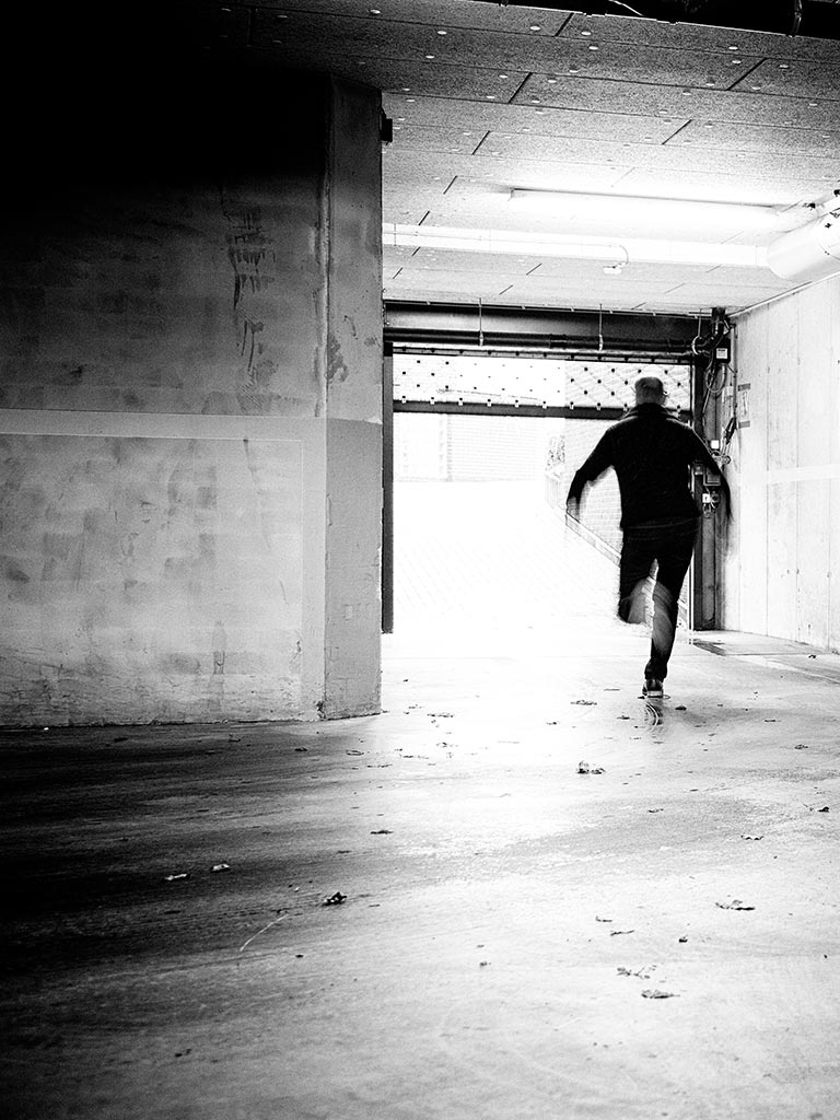 main character from rogue genes running down a dark lane